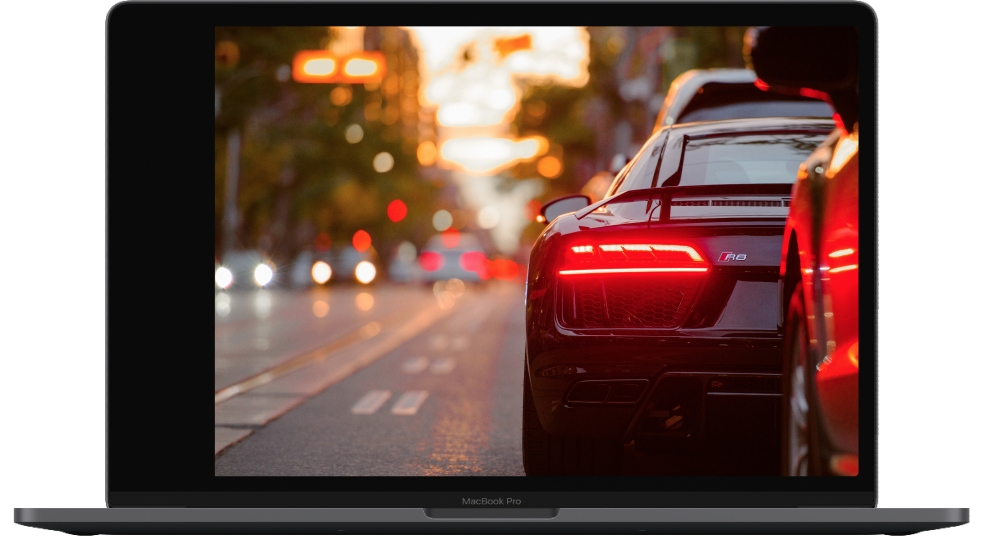 Laptop with car on a road.